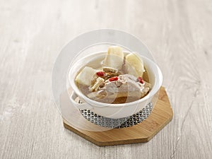 Double-boiled Spare Rib Soup with Chinese Yam and Snow Pear with chopsticks served in a dish isolated on mat side view on grey