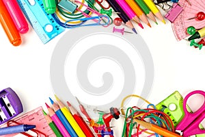 Double border of school supplies over white photo