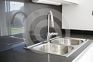 A double bowl stainless steel kitchen sink in a modern design