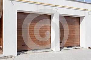 Double brown garage door in a new house.