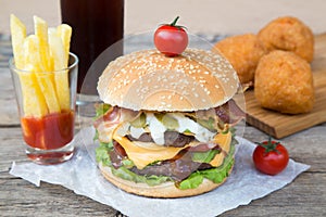 Double burger with french fries and fried balls
