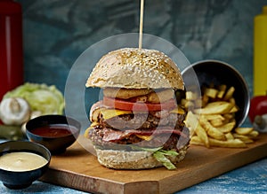 Double burger with fries on a textured background