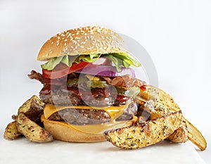 Double cheeseburger with potatoes on white background