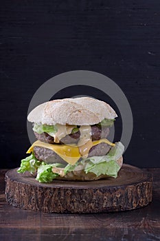 Double cheeseburger on a wooden board