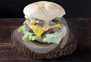 Double cheeseburger on a wooden board