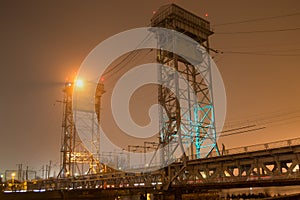 Double-deck drawbridge at foggy night