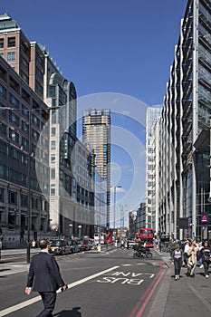 Double deck red bushes service on the busy high street in London surrounded by skyscraper building landscape view