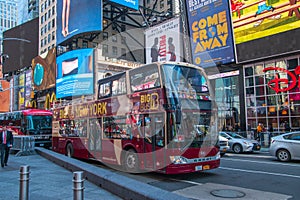 Double decker hop on / hop off tour bus seen on broadway in Times Square Manhattan New York City