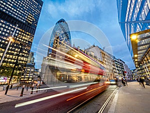 Double decker red bus in motion on the road in London