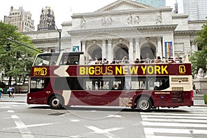 Double-decker tour bus in front of the New York City Library