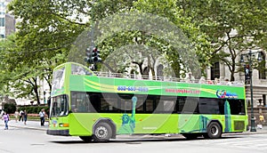 Double-decker tour bus in front of the New York City Library