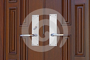 Double door handles on mahogany photo