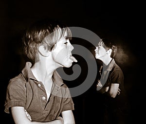 Double-exposed portrait of red-haired emotive freckled boy