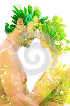 Double exposure of a beautiful young couple combined with bright green leaves