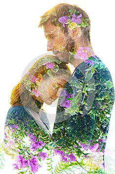 Double exposure of a beautiful young couple combined with bright green leaves