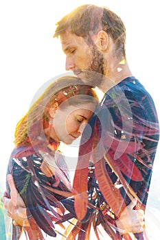 Double exposure of a beautiful young couple combined with bright green leaves