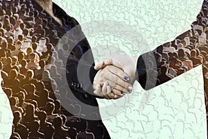 Double exposure of business handshake with motion crowd