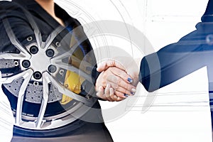 Double exposure of business handshake with wheel car