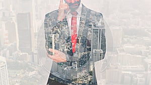 Double exposure with business man and city