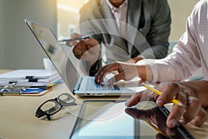 Double exposure of business man hand working on laptop computer on wooden desk with social media network diagram