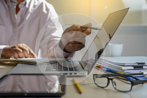 Double exposure of business man hand working on laptop computer on wooden desk with social media network diagram