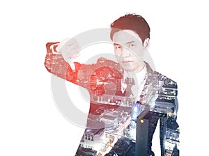 Double exposure of business man showing thumbs down gesture against city isolated on white background