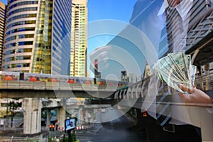 Double exposure of business man in suit with transportation system and city scape backgrond.business take money to invest in