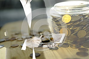 Double exposure of business man using tablet and golden coins in jar, technology and banking investment concept