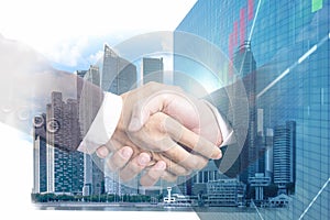 Double exposure of business partner handshake and Display stock market investment trading , Business analyzing financial