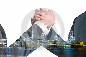 Double exposure of Business people gripping hands on Power plant