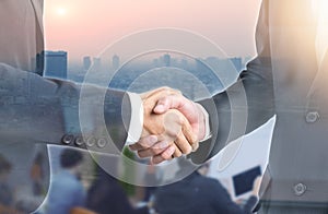 Double exposure of Business people handshake wearing suits on building