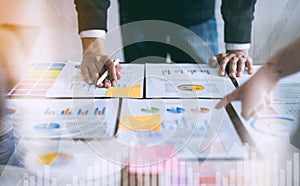 Double exposure of business people meeting team working on wooden desk.