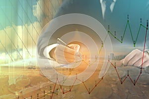 Double exposure of businessman with cityscape, coins and graph