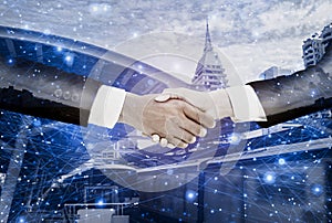 Double exposure-businessman handshake with  businesswoman deal and agree to negotiate mission complete,background cityscape with