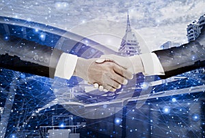 Double exposure-businessman handshake with  businesswoman deal and agree to negotiate mission complete,background cityscape with photo