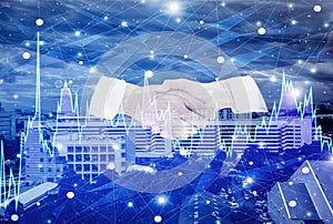Double exposure-businessman handshake with businesswoman  negotiate mission complete,background cityscape and graph stock  with photo