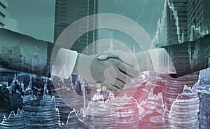 Double exposure-businessman handshake,cityscape and stack of coins,graph stock chart background,With concept of financial and