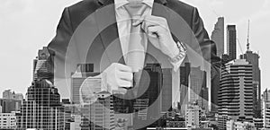 Double exposure businessman holding neck tie with modern buildings in Bangkok city background, Black and White