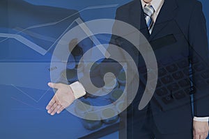 Double exposure of businessman shaking hand with stack of coins