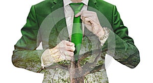 Double exposure businessman tying green necktie and big tree