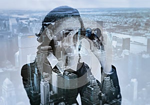 Double exposure of businesswoman with binocular and megalopolis