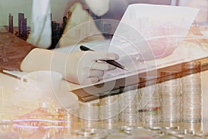 Double exposure of businesswoman with cityscape and coins