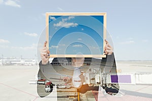 Double exposure of businesswoman holding board with aeroplane