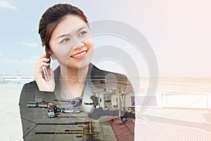 Double exposure of businesswoman using phone with aeroplane