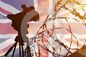 Double exposure - camera, barbed wire and flag United Kingdom