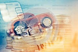 Double exposure of car on rows of coins and credit card , business and finance background