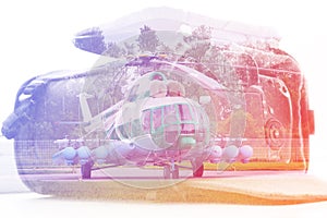 Double exposure: carrying case for the camera and a helicopter. Business, press, resque and travel concept.