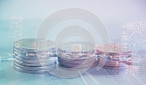 Double exposure of city and rows of coins