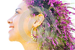 Double exposure close up profile portrait of a young pretty woman interwoven with bright purple Bougainvillea flowers seemingly