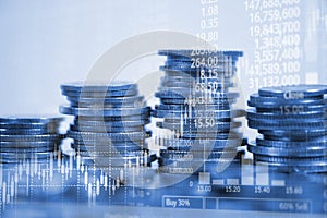 Double exposure of coin stack with stock market screen chart boa